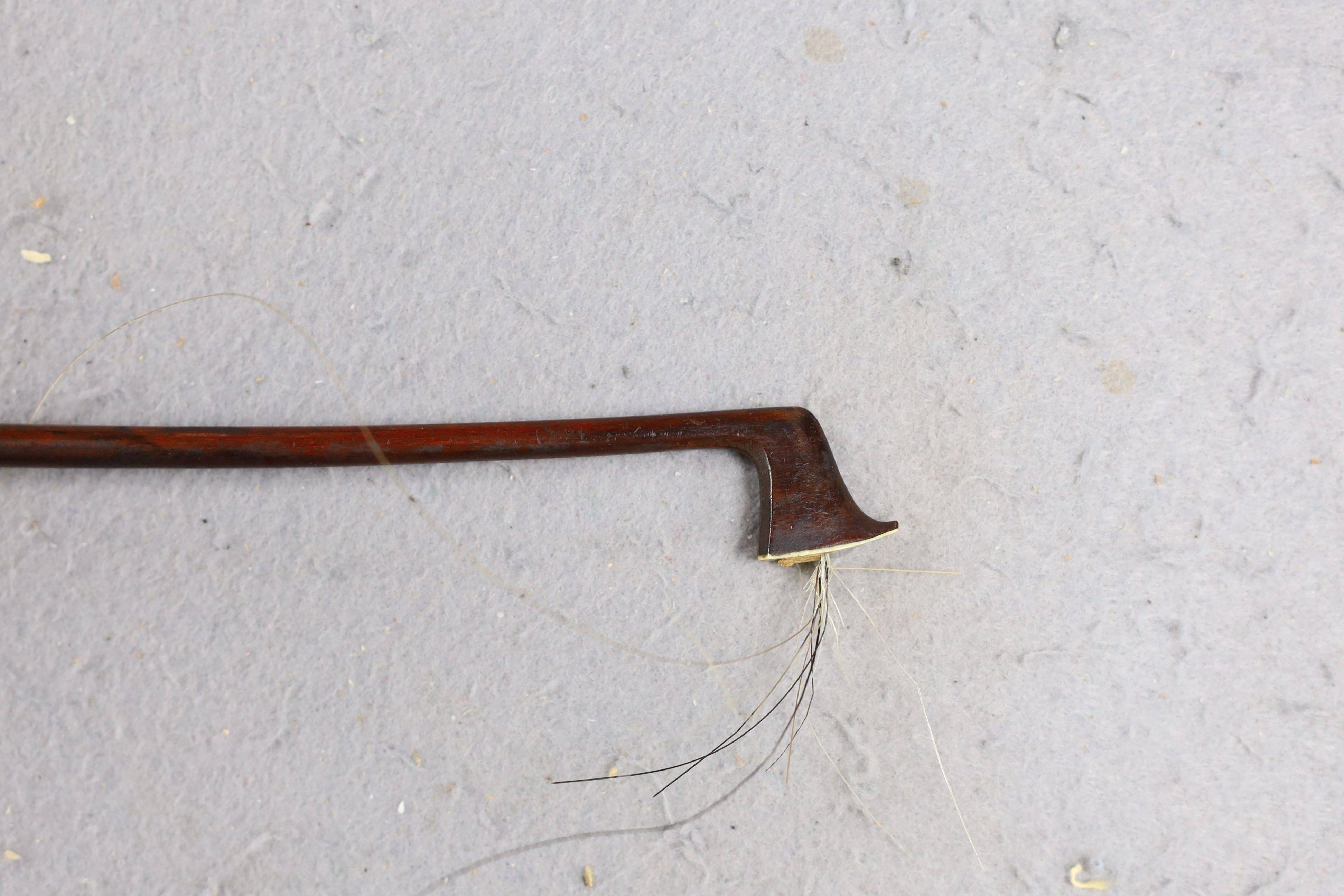 A cased 19th century violin, labelled Stradivarius 1690, with a Dodd bow